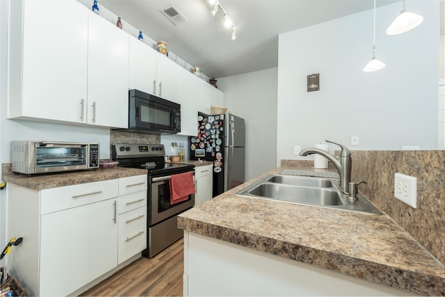 kitchen featuring white cabinetry, sink, appliances with stainless steel finishes, and dark hardwood / wood-style flooring