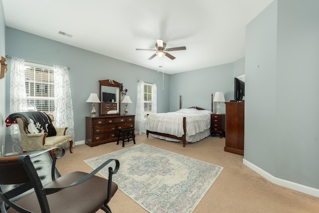 bedroom with light carpet and ceiling fan