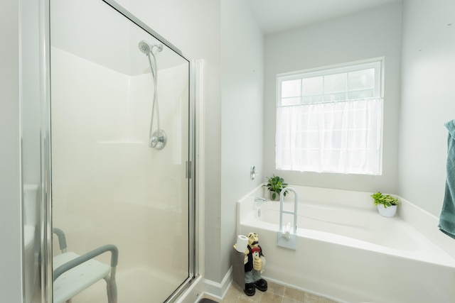 bathroom with tile patterned flooring and separate shower and tub