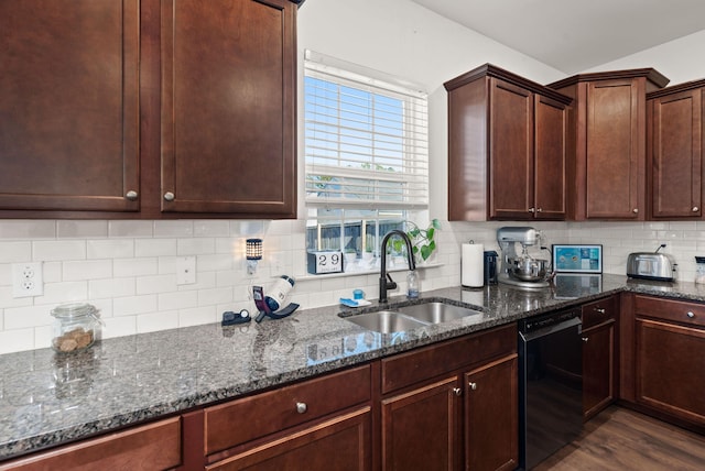 kitchen with sink, backsplash, black dishwasher, dark hardwood / wood-style flooring, and dark stone counters