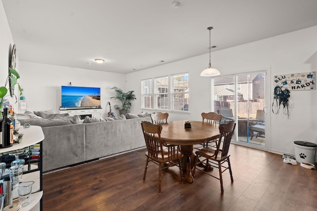 dining area with dark hardwood / wood-style floors