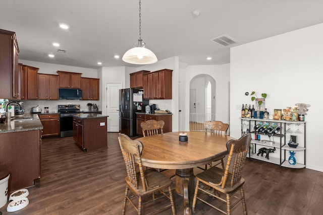 dining area with sink and dark hardwood / wood-style floors