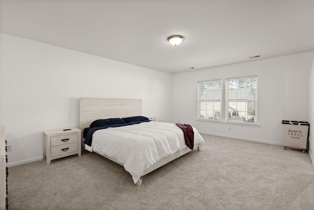 bedroom with light colored carpet