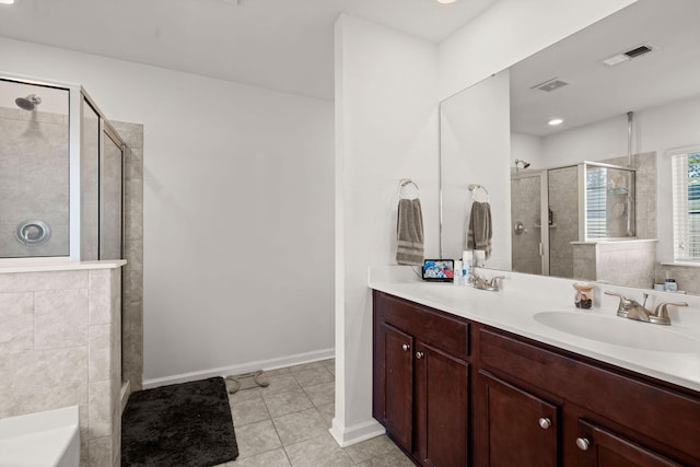 bathroom featuring tile patterned floors, a shower with shower door, and vanity