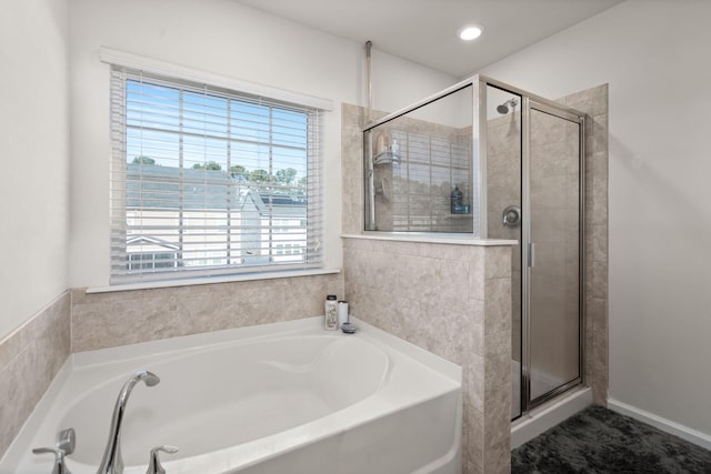 bathroom featuring separate shower and tub