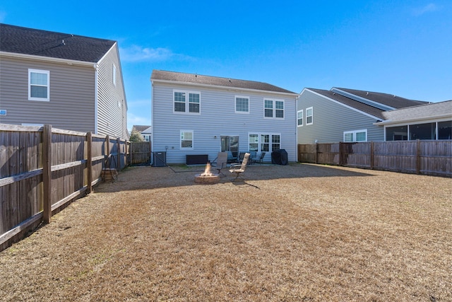 back of house with a patio area, central air condition unit, and an outdoor fire pit