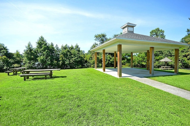 view of home's community with a gazebo, a patio area, and a lawn