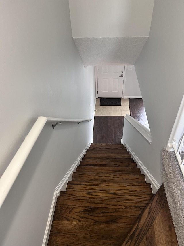 staircase featuring baseboards