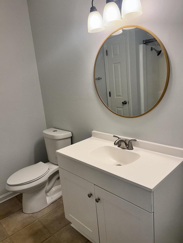 bathroom with vanity, tile patterned flooring, and toilet