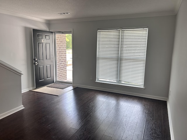 foyer with wood-type flooring, baseboards, and ornamental molding
