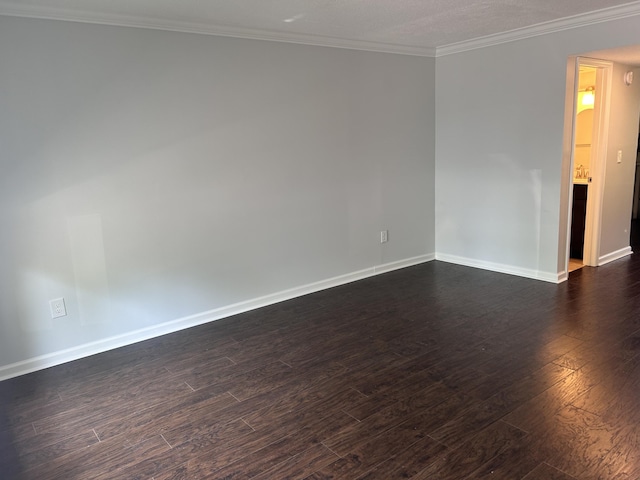 empty room with crown molding, baseboards, and dark wood-style flooring