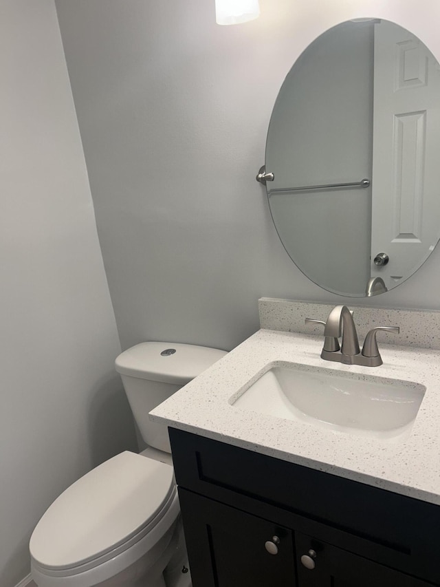 bathroom with toilet and vanity