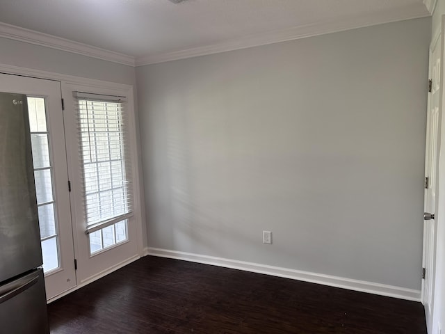 unfurnished room featuring baseboards, dark wood finished floors, and a wealth of natural light