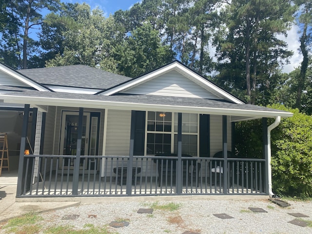 687 Ponderosa Dr, Charleston, SC 29414 - view of side of property with a shingled roof and covered porch