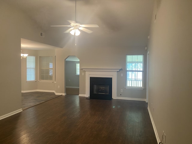 687 Ponderosa Dr, Charleston, SC 29414 - unfurnished living room featuring ceiling fan, arched walkways, dark wood finished floors, a fireplace with flush hearth, and high vaulted ceiling