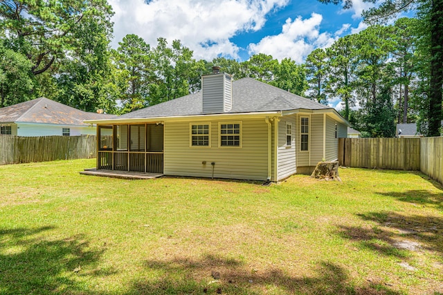 687 Ponderosa Dr, Charleston, SC 29414 - back of property with a fenced backyard, a chimney, a sunroom, and roof with shingles