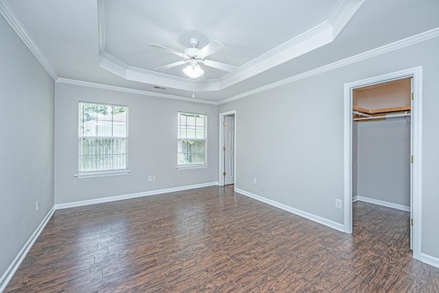 687 Ponderosa Dr, Charleston, SC 29414 - unfurnished bedroom featuring a tray ceiling, wood finished floors, crown molding, a walk in closet, and ceiling fan
