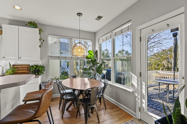 dining space with a healthy amount of sunlight and light hardwood / wood-style floors