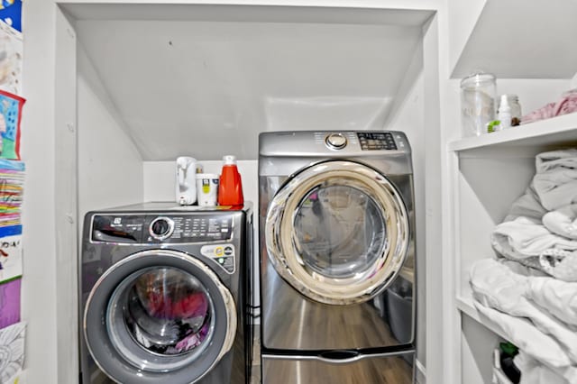 laundry room featuring hardwood / wood-style floors and washer and dryer