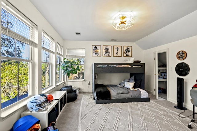 bedroom with light carpet and vaulted ceiling