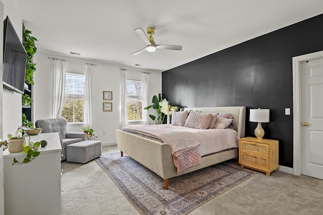 bedroom featuring ceiling fan and light carpet