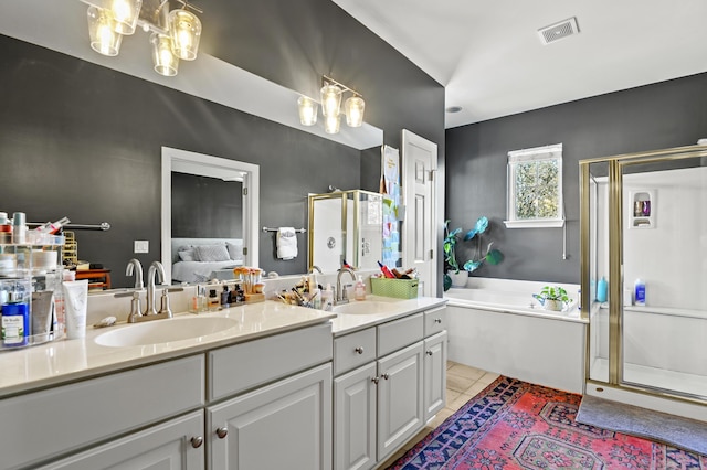 bathroom with independent shower and bath, vanity, a notable chandelier, and tile patterned flooring