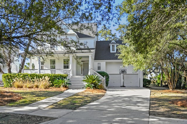 view of front facade featuring a porch and a garage