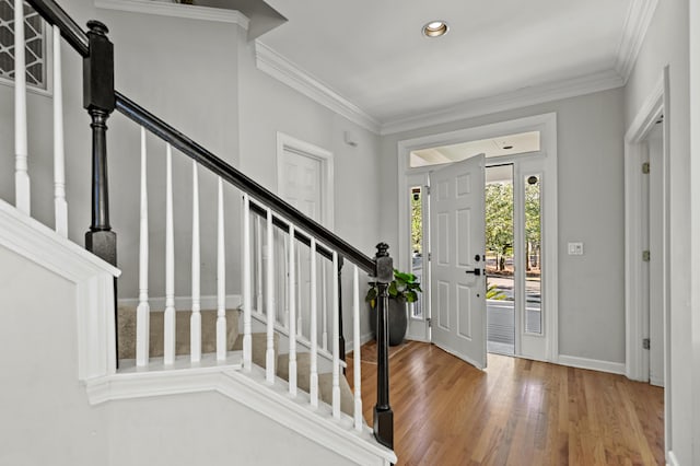 entrance foyer with hardwood / wood-style flooring and ornamental molding