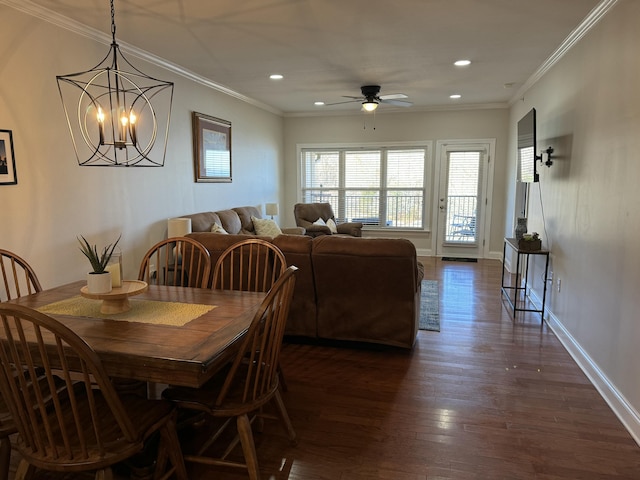 dining space featuring crown molding, ceiling fan with notable chandelier, and dark hardwood / wood-style floors