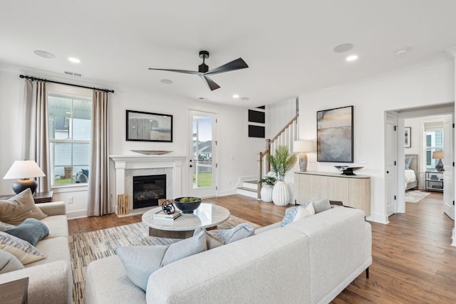 living room with ceiling fan, crown molding, and hardwood / wood-style floors