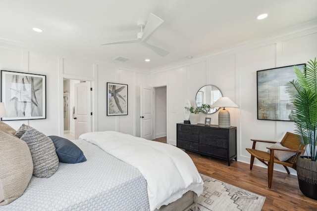 bedroom featuring ceiling fan, dark hardwood / wood-style flooring, and crown molding