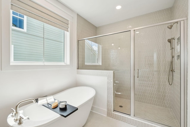 bathroom with separate shower and tub and tile patterned flooring