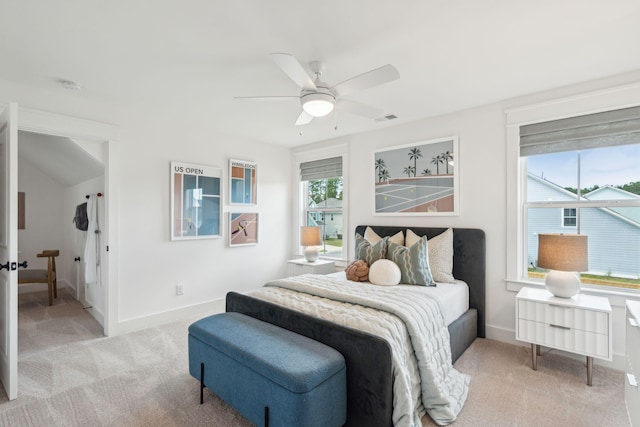 carpeted bedroom featuring ceiling fan and multiple windows