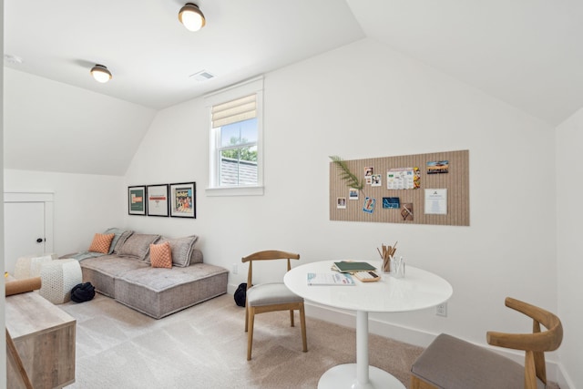 carpeted living room with vaulted ceiling