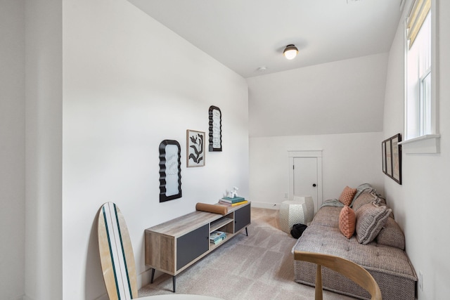 living room with lofted ceiling and light colored carpet