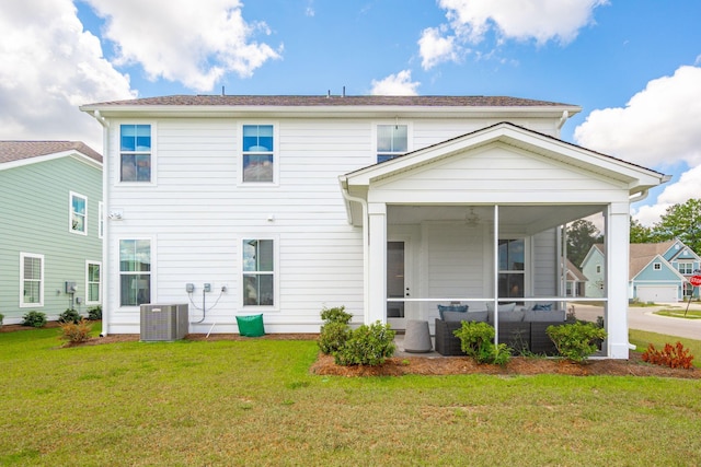 back of house with cooling unit, a sunroom, a lawn, and an outdoor hangout area