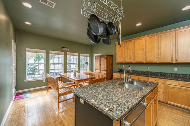 kitchen featuring light wood-style floors, visible vents, a sink, and stainless steel dishwasher