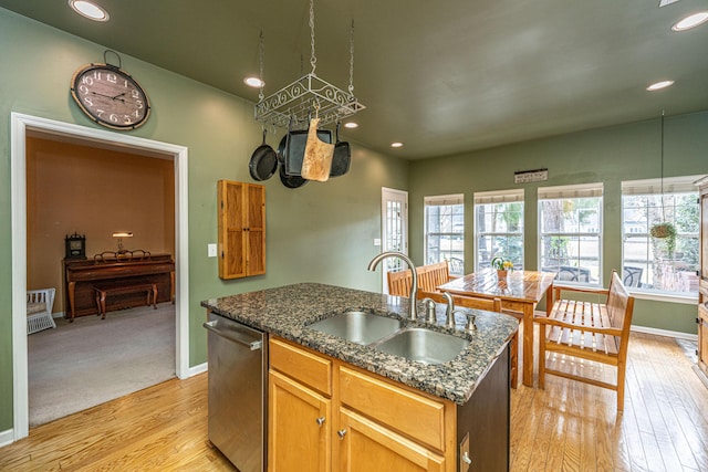 kitchen featuring a sink, a healthy amount of sunlight, a kitchen island with sink, and stainless steel dishwasher