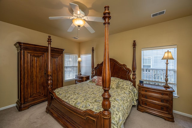 bedroom with light carpet, baseboards, visible vents, and ceiling fan