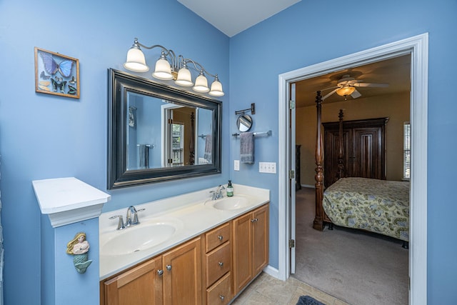 full bathroom featuring ceiling fan, double vanity, a sink, and connected bathroom