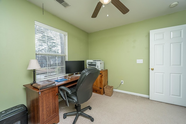 home office featuring baseboards, visible vents, a ceiling fan, and light colored carpet