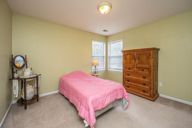 carpeted bedroom featuring visible vents and baseboards