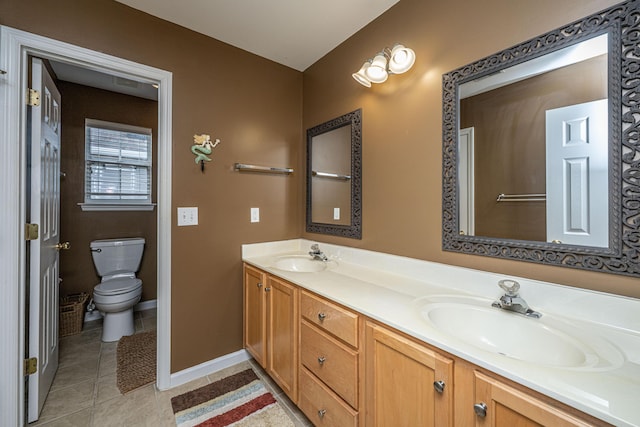 full bath with tile patterned floors, a sink, toilet, and double vanity