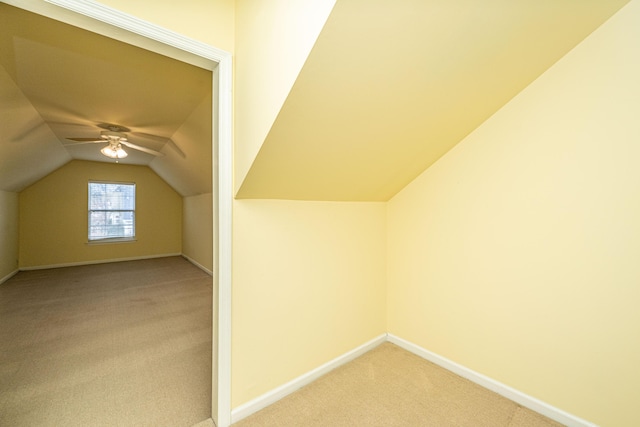 additional living space featuring carpet, vaulted ceiling, and baseboards