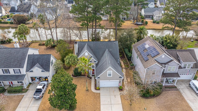 bird's eye view with a water view and a residential view