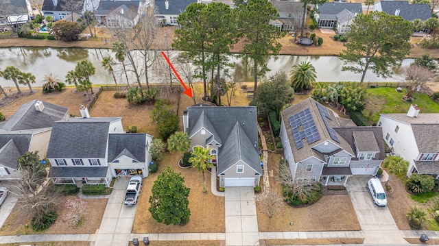 drone / aerial view featuring a water view and a residential view