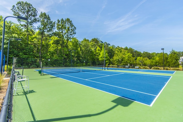 view of sport court featuring fence