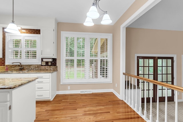320 Compton Xing, Summerville, SC 29485 - kitchen with a sink, light wood-type flooring, white cabinetry, and healthy amount of natural light