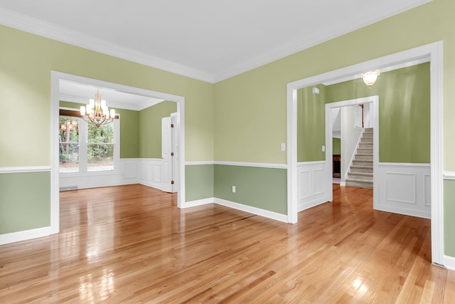 320 Compton Xing, Summerville, SC 29485 - unfurnished room featuring a chandelier, stairs, light wood finished floors, ornamental molding, and wainscoting