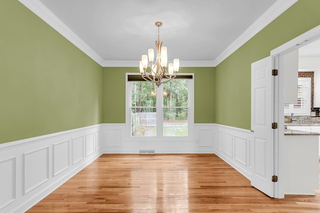 320 Compton Xing, Summerville, SC 29485 - unfurnished room featuring a chandelier, a wainscoted wall, light wood-type flooring, and crown molding